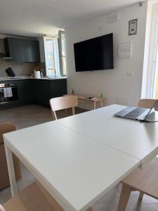 a white table with a laptop on it in a kitchen at A Casa di Gaia 2 in San Benedetto +70 photos