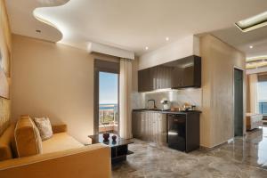 a living room with a couch and a kitchen at Aphrodite of Thassos in Skala Marion