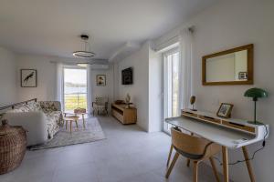 a living room with a couch and a table at Un Occhio Sul Lago in Dormelletto