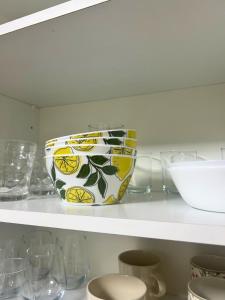 a bowl on a shelf in a kitchen with glasses at Apartamento en A Coruña in A Coruña +12 photos