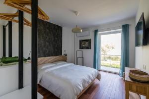 a bedroom with a bed and a large window at Un Occhio Sul Lago in Dormelletto +107 photos
