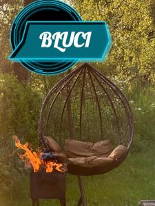 a bird cage sitting next to a fire at Bluci seksti in Seksti