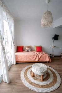 a bedroom with a bed with red pillows and a table at Hotel Beach Pool Punta Cana Vacation in Punta Cana +36 photos