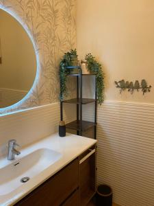 a bathroom with a sink and a mirror at La Morra Relax in La Morra +44 photos