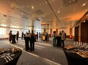 a group of people standing in a banquet hall at Crowne Plaza Zürich by IHG in Zurich +101 photos