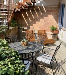 a patio with a table and chairs and stairs at La Morra Relax in La Morra