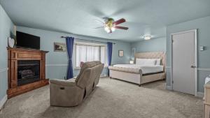 a bedroom with a bed and a ceiling fan at Black Bear Manor in Ouray