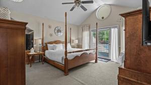a bedroom with a canopy bed and a balcony at Black Bear Manor in Ouray