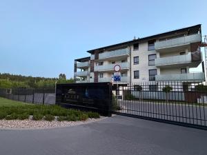 a black fence in front of a building at Apartament Brzeg in Augustów