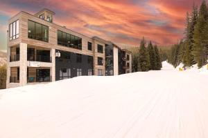 a building on a snow covered slope in front at NEW Ski-In Ski-Out Romantic Studio for Two in Winter Park