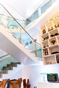 a staircase in a house with glass shelves at Bara's Hotel in Bom Conselho