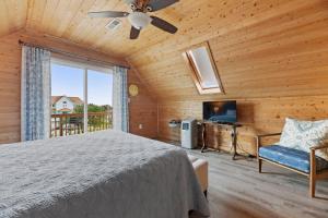 a bedroom with a bed and a tv and a window at Sunshine Days OBX in Nags Head