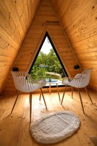 a room with two chairs and a table in a attic at Rzav A - Frames in Arilje