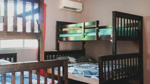 two bunk beds in a room with a bed at Cabañas de Asgard in Nueva Gorgona +20 photos