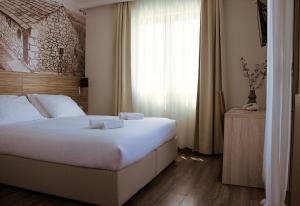 a hotel room with a bed and a window at Hotel Luna in Međugorje