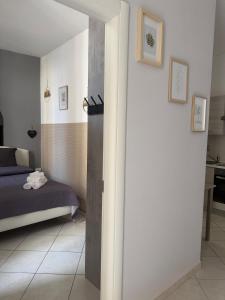 a bedroom with a bed and a wall with a column at Al Vicolèt in Vercelli
