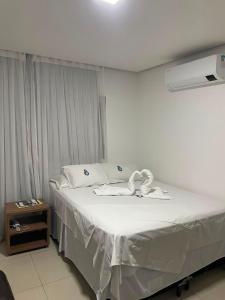 a bedroom with a bed with white sheets at Bara's Hotel in Bom Conselho +39 photos