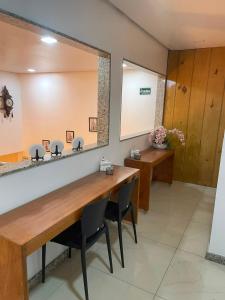 a waiting room with a mirror and two desks at Bara's Hotel in Bom Conselho