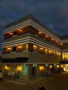 a large building with lights on it at night at Bara's Hotel in Bom Conselho