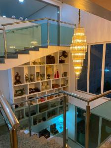 a room with a staircase and a chandelier at Bara's Hotel in Bom Conselho