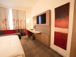 a hotel room with a bed and a sink at Novotel Konya in Konya