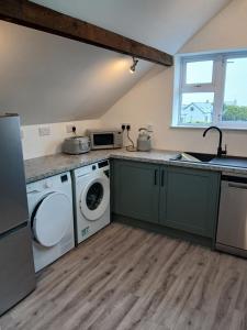 a kitchen with a washing machine and a dishwasher at Roshinehill apartment in Shanbally