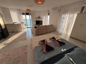a living room with a bed and a couch at Blue luxury apartment Kune in Sakës