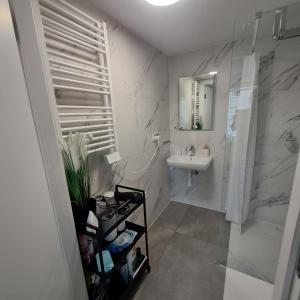 a white bathroom with a sink and a mirror at Welle DOLCE VITA in Grzybowo +22 photos