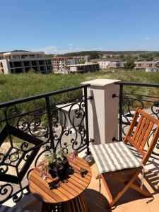 a balcony with two chairs and a table with a view at Студио Морски бриз in Sozopol