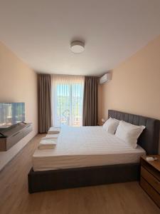 a large bedroom with a large bed and a window at Студио Морски бриз in Sozopol +18 photos