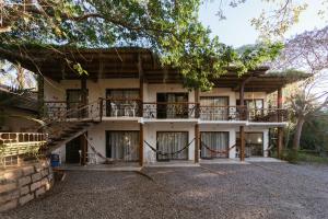 a house with a staircase in front of it at Hotel Chácara das Flores in São Gabriel
