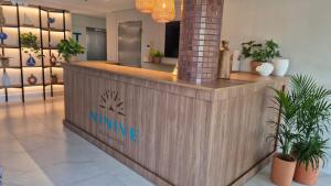 a counter in a store with potted plants at Niníve Boutique Hotel in Cabedelo +26 photos