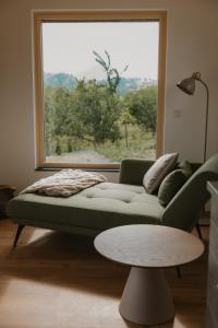 a living room with a couch and a window at Natururlaub by Klotz TINY HAUS a in Überlingen