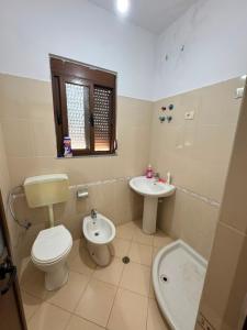a bathroom with a toilet and a sink at General's Beach House in Kavajë