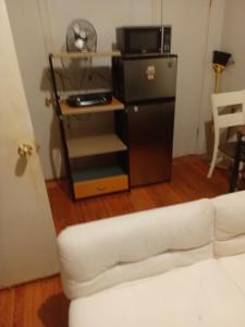 a living room with a white couch and a microwave at Anderson home services in Woodlawn +13 photos