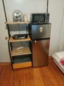 a small kitchen with a microwave and a refrigerator at Anderson home services in Woodlawn