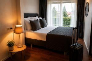 a hotel room with a bed and a window at Hotel Hof van Gelre by Flow in Lochem +16 photos