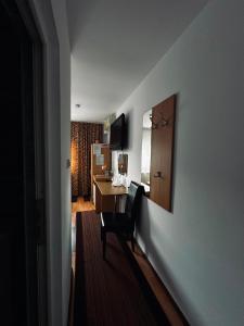 a room with a desk and a chair in a hotel room at Hotel Mya in Bistriţa