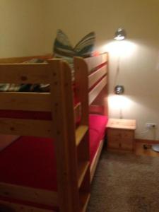 a bedroom with two bunk beds and a lamp at Ferienhaeuser-Am-Eichenberg-Haus-1 in Blankenburg