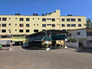 a large building with a tent in front of it at Marie's 2bed all-ensuite Tuffoam 310 in Kisumu