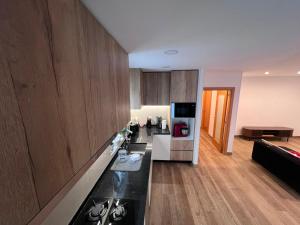 a kitchen with wooden cabinets and a counter top at Casa do Rio in Freixieiro de Soutelo +16 photos
