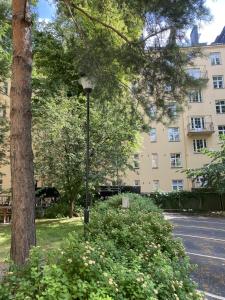 a street light next to a tree and a building at HHH Perfect location right in Helsinki center, walking distance to Kamppi and railway station in Helsinki