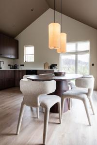 a dining room with a table and two chairs at Modern Cabin with Hot Tub & Mountain views in Varmaland