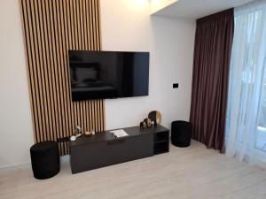 a living room with a flat screen tv on a wall at White Titanic 322 in Mamaia Sat/Năvodari