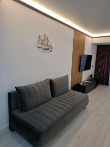 a living room with a couch and a tv at White Titanic 322 in Mamaia Sat/Năvodari +21 photos
