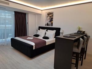 a bedroom with a bed and a desk in a room at White Titanic 322 in Mamaia Sat/Năvodari