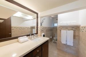 a bathroom with a sink and a toilet at Rooftop Oasis Steps from the Malecon in La Paz +46 photos