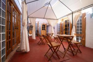 a room with tables and chairs in a building at Karrizo lodge in San Pedro de Atacama