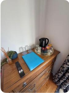 a wooden dresser with a coffee pot on top of it at Valley View in Port Isaac