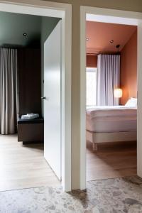 a bedroom with a bed and a window at Modern Cabin with Hot Tub & Mountain views in Varmaland